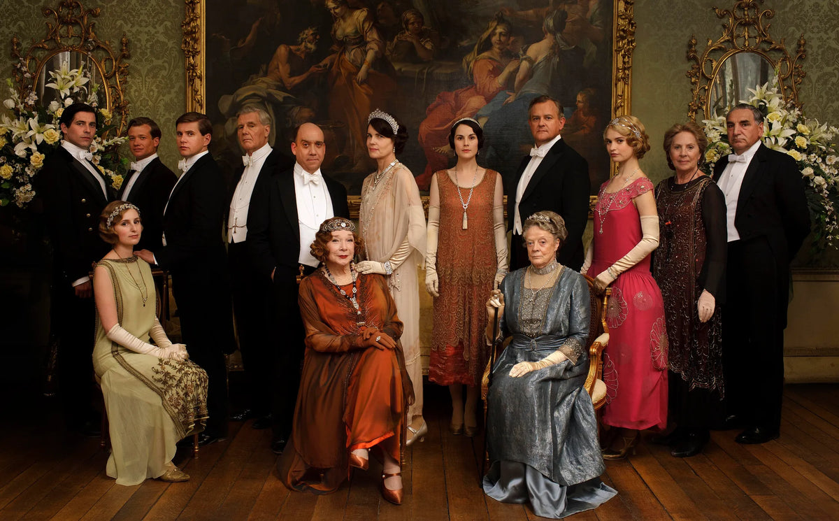 Group of people in formal attire in a room with classical decor