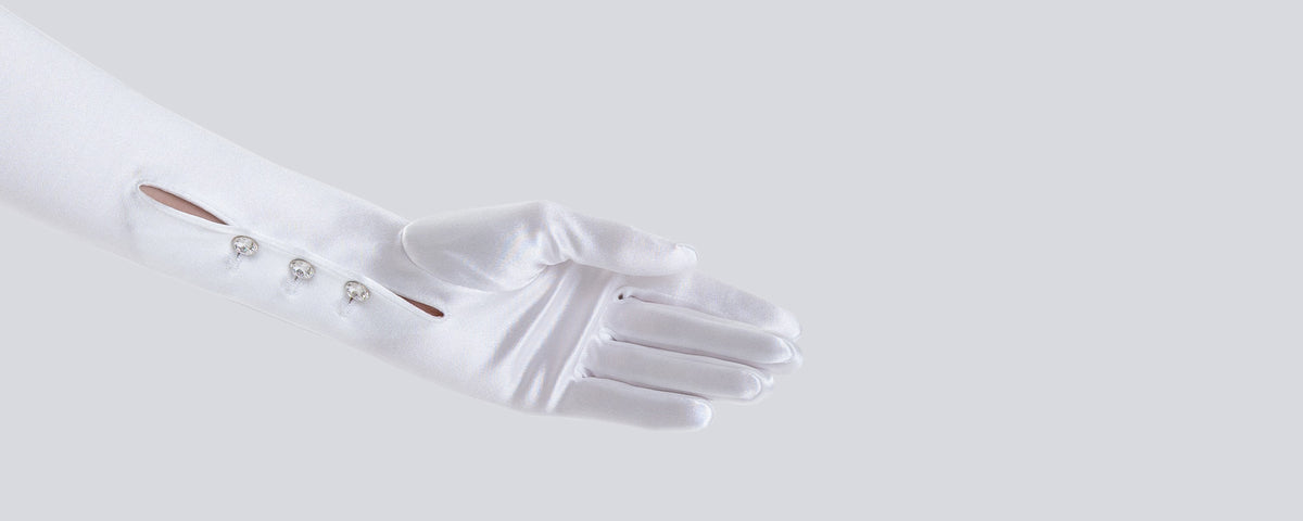 White satin glove with decorative elements on a light gray background
