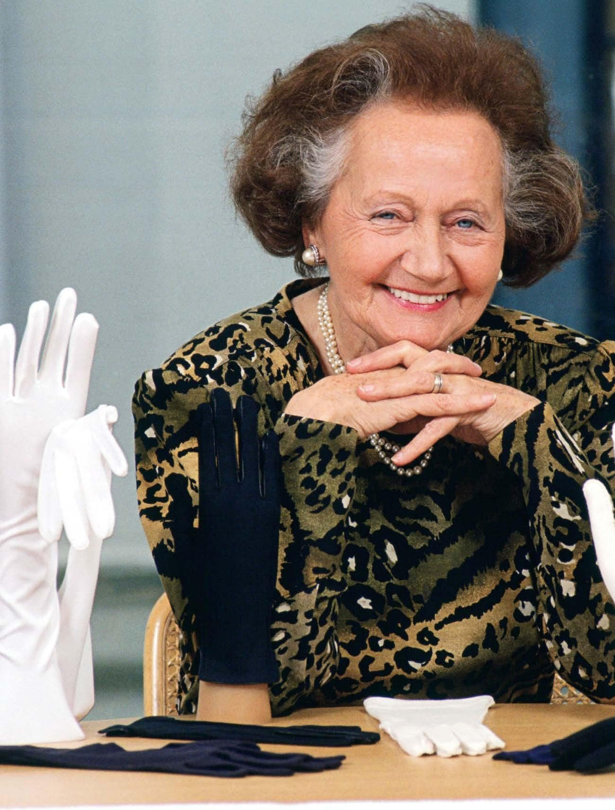 Cornelia James, founder and glovemaker by Royal Appointment, with white and navy handmade gloves