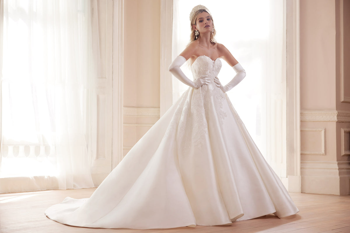 Bride in an ivory ball gown wearing long white bridal opera gloves